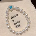 Elegant vintage pearl bracelet featuring a blue heart-shaped crystal centerpiece - Heart-shaped Blue Gemstone Style (HB6118) / 1 Piece / Silver