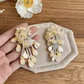 Detail view of yellow floral tassel earrings with beaded fringe and petal accents - Flower Tassel Style (HE32829) / Yellow