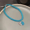 Detailed macro view of blue frosted glass bead double-layer necklace with flower charm - Double Layer Flower / Silver-Blue