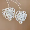 Close-up of intricate white beaded flower earrings with a hanging teardrop pearl. - French Beaded Flower Pearl Style / Silver Earring Post-White