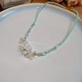 French style light green beaded necklace with white flower pendant for women. - Beaded Flower / Green
