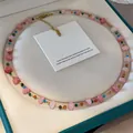 Elegant French style necklace with pink and multi-colored glass beads on gold chain. - Faceted Glass Beads / Pink