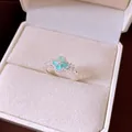 Macro detail of a silver ring featuring a turquoise flower motif with sparkling zircons - Blue Flower / Silver