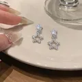 Close-up detail of Korean style silver star drop earrings with sparkling crystals - Double Star Drop Style (HE33275) / Silver