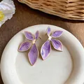 Elegant purple enamel leaf stud earrings with gold trim and marble texture finish. - Gold-Purple