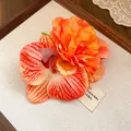 Detailed view of the vibrant orange fabric peony and orchid flower hair clip texture. - Orange Peony Style / Single Piece / Orange