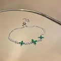 Close-up of elegant silver-toned bracelet featuring green zircon flowers and sliding clasp - Green Marquise Zirconia Flower Style (HB5459)