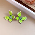 Close-up of green enamel butterfly earrings with sparkling rhinestones - Golden Butterfly Rhinestone Earrings / 925 Silver Needle / Green