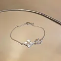 Dainty silver chain bracelet featuring a zircon flower and white shell quatrefoil charm - Mother Of Pearl Clover Style (HB5459)
