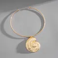 Close-up of vintage gold conch shell pendant on a minimalist metal choker necklace - Gold