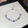 Detailed view of 18k gold plated bracelet with shimmering oval and flower zirconia stones - White Oval Flower Style / Silver