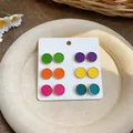 Detail view of six pairs of colorful enamel round stud earrings on a white display card. - Style 4 Multicolor