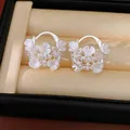 Close-up of elegant flower basket earrings featuring white pearls and sparkling zircons - Ear Buckle / White