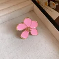 Detailed close-up of elegant vintage pink enamel flower open ring in a jewelry display box - Pink