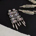 Macro view of exquisite gold chandelier earrings with multi-colored shimmering rhinestones - Silver (Silver Pin)