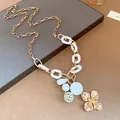 Detail shot of vintage gold flower pendant necklace with white resin chain segments. - Gold and White Splicing (Necklace)