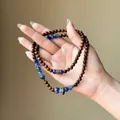 Detail of retro wooden beaded bracelet with blue marble stone beads in ethnic style - Beaded Style / Blue-Brown