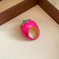 Detailed view of the vibrant pink enamel strawberry ring with gold-tone band - Strawberry Shape / Pink