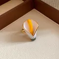Close-up detail of a handmade Calla Lily flower ring with white and yellow enamel finish - Calla Lily Shape / Gold-White