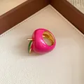 Macro view of a vibrant pink enamel strawberry ring with gold accents and green leaf detail - Apple Shaped / Gold-Pink