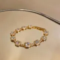 Macro view of luxurious 18k gold plated bracelet with sparkling square zircons - Gold