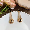 Detailed view of elegant gold-toned water drop earrings featuring a unique black keyhole design - Waterdrop Keyhole Long Style
