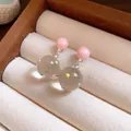 Close-up detail of ice-transparent polka dot glass ball drop earrings in a box - Ball Pendant (Silver Post) / Pink