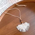 Exquisite detail of bohemian hand-woven straw fan pendant necklace with fabric flowers - Necklace-Beige