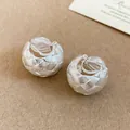 Elegant silver-toned woven C-shaped clip-on earrings with premium textured finish - Clip-On Earrings / Silver