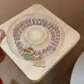 Nahaufnahme eines eleganten Doppel-Perlenarmbands mit Katzenaugenperlen und Anhänger - Doppelkreis-Kürbis-Anhänger-Stil (37#) / Rosa