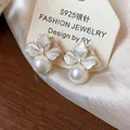 Close-up detail of elegant French floral enamel earrings with pearls and S925 silver pins - Flower Pearl Style (HE31413) / Gold White