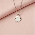 Detail view of a silver stainless steel paw pendant necklace with a sparkling rhinestone. - Steel