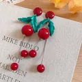 Detailed view of sweet red cherry earrings with green leaves and silver chain tassels - Long Cherry Tassel Dangle / Silver Pin - Red - Green