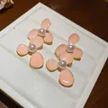 Detailed view of elegant pink enamel flower stud earrings with white pearls. - Enamel Flower Style / 1 Pair Pack / Pink