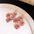 Detail view of statement gold earrings with purple floral print and round charms - Ear Hook-Gold-Purple