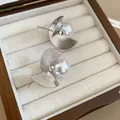 Close-up detail of vintage silver-tone spiral stud earrings featuring elegant white pearls - Spiral Pearl Studs (Silver Post) / Silver