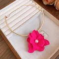 Detailed view of elegant gold choker with a vibrant hot pink flower and pearl center. - Fuchsia Floral / Gold