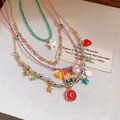 Detailed view of 4-piece vintage resort style necklace set with starfish and heart charms - Necklaces Collection (Gold-Multicolor) / Four-Piece Set
