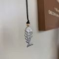 Vintage silver fishbone pendant necklace featuring a black cord and decorative beads - Fishbone / Silver