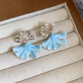 Detail view of silver ginkgo leaf stud earrings with blue marbled enamel finish - Ginkgo Leaf Stud Earrings / Silver-Blue