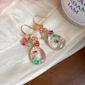 Handmade ethnic style resin earrings with dried flowers and colorful natural stones detail - Pink