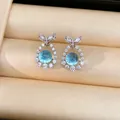 Detail view of silver fish tail stud earrings featuring sparkling zircon and blue center stones - Fish Tail Pendant Stud Earrings (HE34270) / Silver-Blue