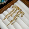 Elegant gold bow stud earrings with sparkling long zircon tassels in a jewelry box. - 8# (HE31465)