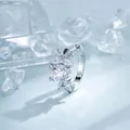 Elegant silver hoop earring featuring a four-petal flower design with sparkling round CZ - Four-Petal Flower Style (A-1431) / White