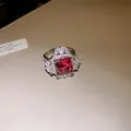 Close-up detail of an elegant red square zircon ring with sparkling diamond-like settings - Open Ring / Silver (Red Stone)
