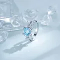 Elegant floral silver hoop earring featuring a brilliant light blue zircon and crystal stones - Four-Petal Flower Style (A-1431) / Light Aquamarine
