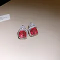 Close-up detail of exquisite square red zircon stud earrings with sparkling halo - Stud Earrings (Silver Pin) / Silver (Red Stone)