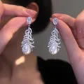 Elegant silver needle earrings featuring zircon feather accents and teardrop pearls - 21# (HE31465)