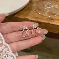 Detailed close-up of pink cat eye heart ear clips with rose gold finish and a bow - Cat Paw Style / Gold-Pink