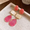 Detailed view of vintage resin drop earrings with square and teardrop elements - Rose Red
